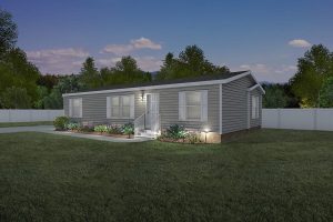 Single-story gray manufactured home with white trim, front steps, and exterior lights on, nestled in the Glenwood Manufactured Home Community, surrounded by grass, shrubs, and a white fence at dusk.